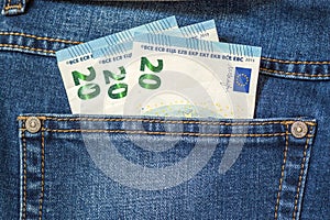 Euro money banknotes in a pocket of blue jeans close up