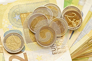 Euro money.Bundle of euro banknotes fan and column of coins.EU currency.Euro banknotes and euro coins.Money and finance.