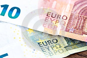 Euro money cash, 10 and 5 euro banknotes as a backdrop for topics such as economics, finance, savings and investment