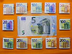 Euro money symbols on an orange bright background photo