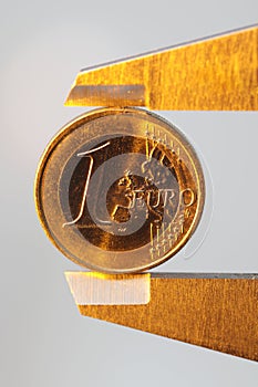 Euro money coin sized by vernier tool
