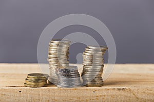 Euro money, currency. Euro coins stack on gray background over wood