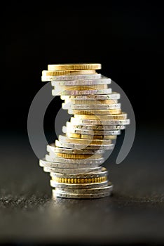 Euro money, currency. Success, wealth and poverty, poorness concept. Euro coins stack on dark black background with copy