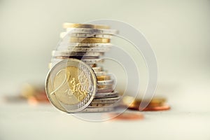 Euro money, currency. Success, wealth and poverty, poorness concept. Euro coins stack on grey background with copy space.