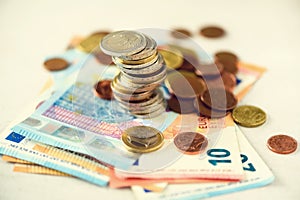 Euro money, currency. Success, wealth and poverty, poorness concept. Euro coins stack on grey background with copy space.