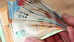 Euro money, stacks of euro banknotes in hands, common currency of euro zone in european union, financial concept, close up