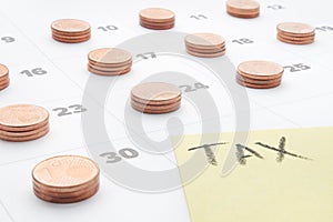 Euro money tax planning budget household utilities calendar tax accounting. Word tax written on yellow paper note with