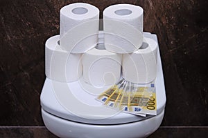 Euro money on the toilet lid, concept. Financial problems due to coronavirus and lack of toilet paper