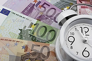 Euro notes and clock. Business concept.