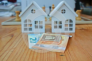 euro notes in front of houses