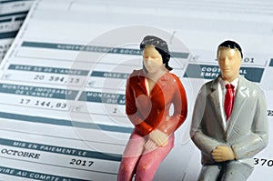 Euro Payroll and woman and man figurine