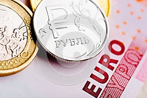 Euro and ruble coins on euro banknotes