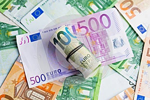 Euro in stationery band on pile of paper banknotes five one hundred and fifty euro. Heap of money