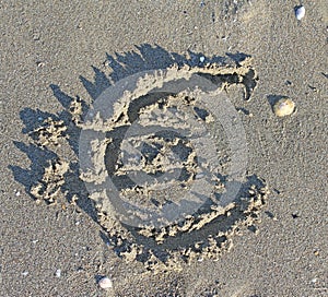 EURO symbol written large on the sand of the Beach