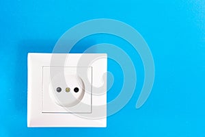 Euro type electrical outlet, electric power point in the house, on a blue background. The concept of power supply, electrical
