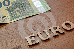 euro word concept made of wooden letters euro on wooden background with flag of European Union