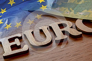 euro word concept made of wooden letters euro on wooden background with flag of European Union