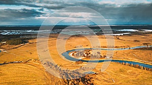 Europe. Aerial View Of Dry Grass And Partly Frozen Curved River Landscape In Autumn Day. High Attitude View. Marsh Bog