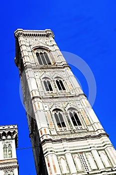 Europe, Italy, Florence, Giotto& x27;s Campanile. Tall clock tower next to the city dome with blue sky background