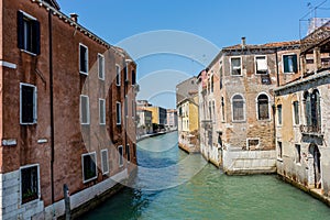 Italy, Venice, Hotel Pantalon, CANAL AMIDST BUILDINGS AGAINST CLEAR SKY photo