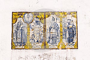 Traditional hand painted azulejos tiles depicting Madonna and Child, and saints Sebastian, Marsal, and Antonio