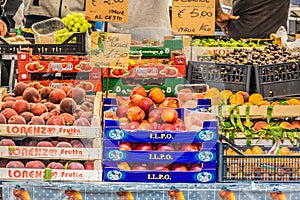 Fresh peaches, nectarines, apricots and other fruits at a market stall in rome, italy. delicious fruit fresh for sale daily.