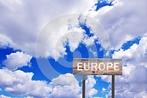 Europe sign on wooden plate. Sign with inscription Europe with view of sky