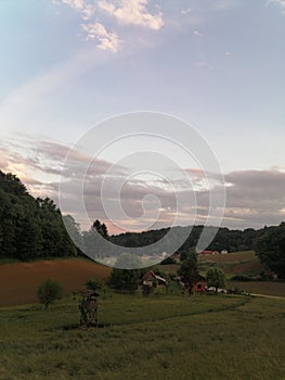 Europe, Slovenia rural landscape with farms, fields, forests and meadows at dusk