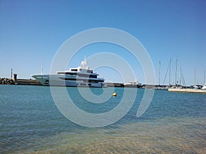 Motor luxury yacht moored on the marina of Ostia town