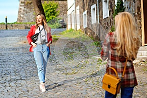Europe vacation. Girls taking selfie photo at street. Stylish trendy outfit, street style