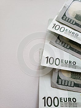 European banknotes of 100 euro and american 100 dollars bills on white background