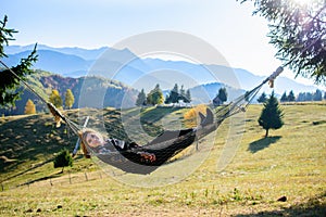 Relaxation. Women in hammock in autumn. mountain view photo