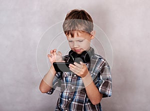 European boy listening to music on your smartphone with headphones