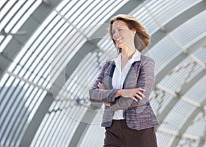 European business woman smiling with arms crossed