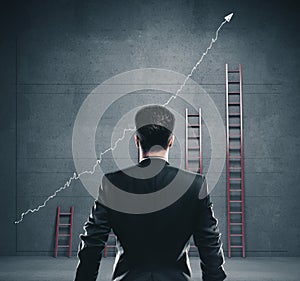 European businessman looking on white arrow and ladders