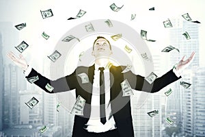 European businessman standing under dollars rain