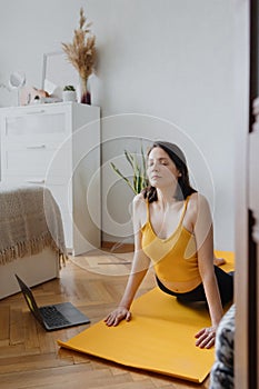 European caucasian woman does home yoga and meditation