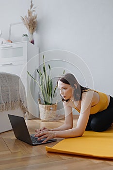 European caucasian woman does home yoga and meditation