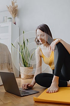 European caucasian woman does home yoga and meditation