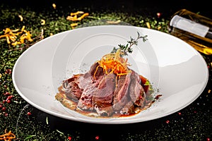 European cuisine. Marinated veal with roast Medium rare. Degree of roasting. Chef pours beef olive oil. Serving dishes