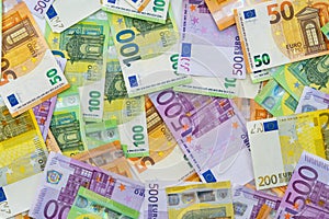 European currency lies on the table. Banknotes five hundred, one hundred, two hundred, fifty euros are scattered in a chaotic mann