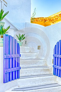 European Destinations. Ancient Blue Gates and White Stairs in One of Oia Village Houses on Santorini Island in Greece