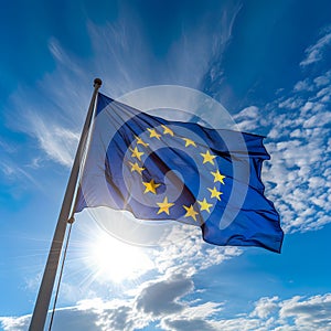 European EU flag, unfurled in all its glory on a sunny day against the clear blue sky.