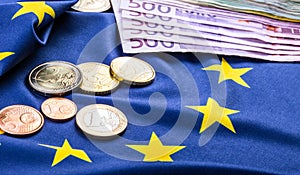 European flag and euro money. Coins and banknotes European currency freely laid on the Eur