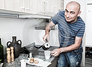 European guy pours coffee into cup of coffee pot photo