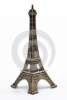 European landmarks, travelling to Paris and parisian ornament concept with miniature metallic eiffel tower isolated on white