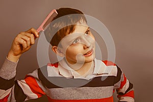 European-looking boy of ten years combing her hair