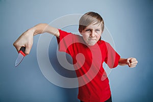 European-looking boy of ten years holding a knife