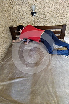 European man cover bedcover on bed in bedroom
