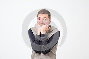 European man covering his mouth with both hands, looking shocked. photo